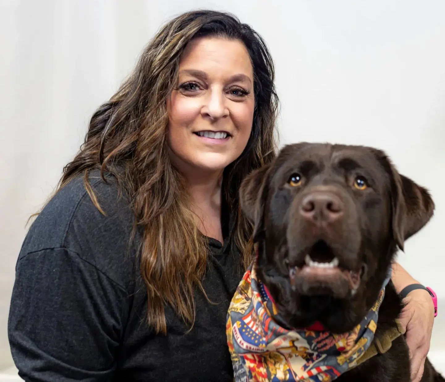 A woman and her dog pose for the camera.