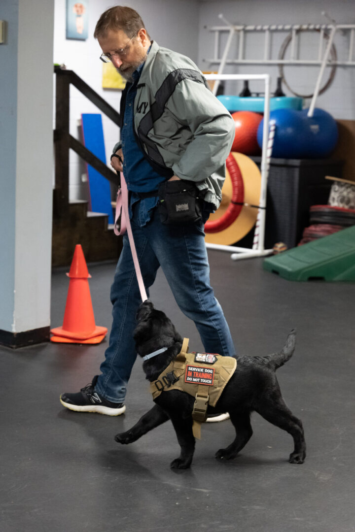 A man walking his dog on the leash.