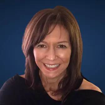 A woman with brown hair and black shirt smiling.